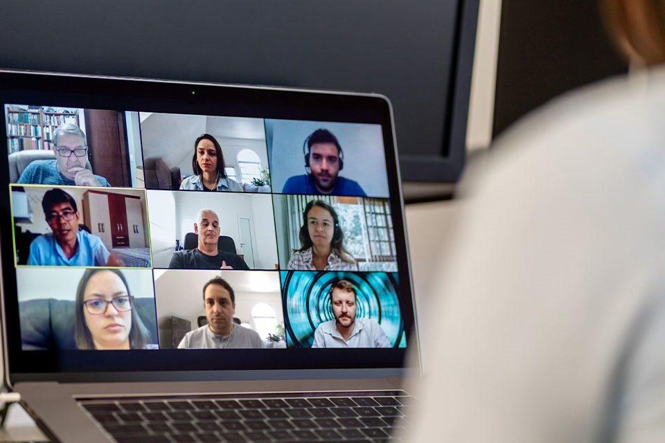 A person on a zoom call, with the small class, as they learn from home.  